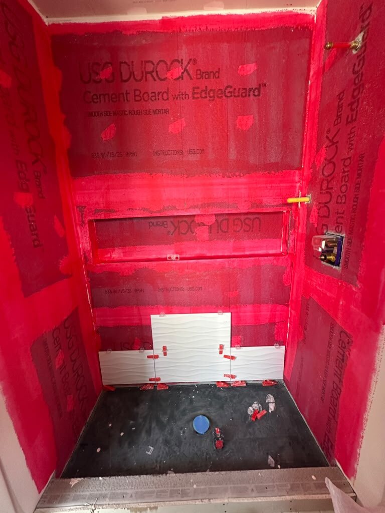 Waterproofing membrane bonded over cement board before tile goes on